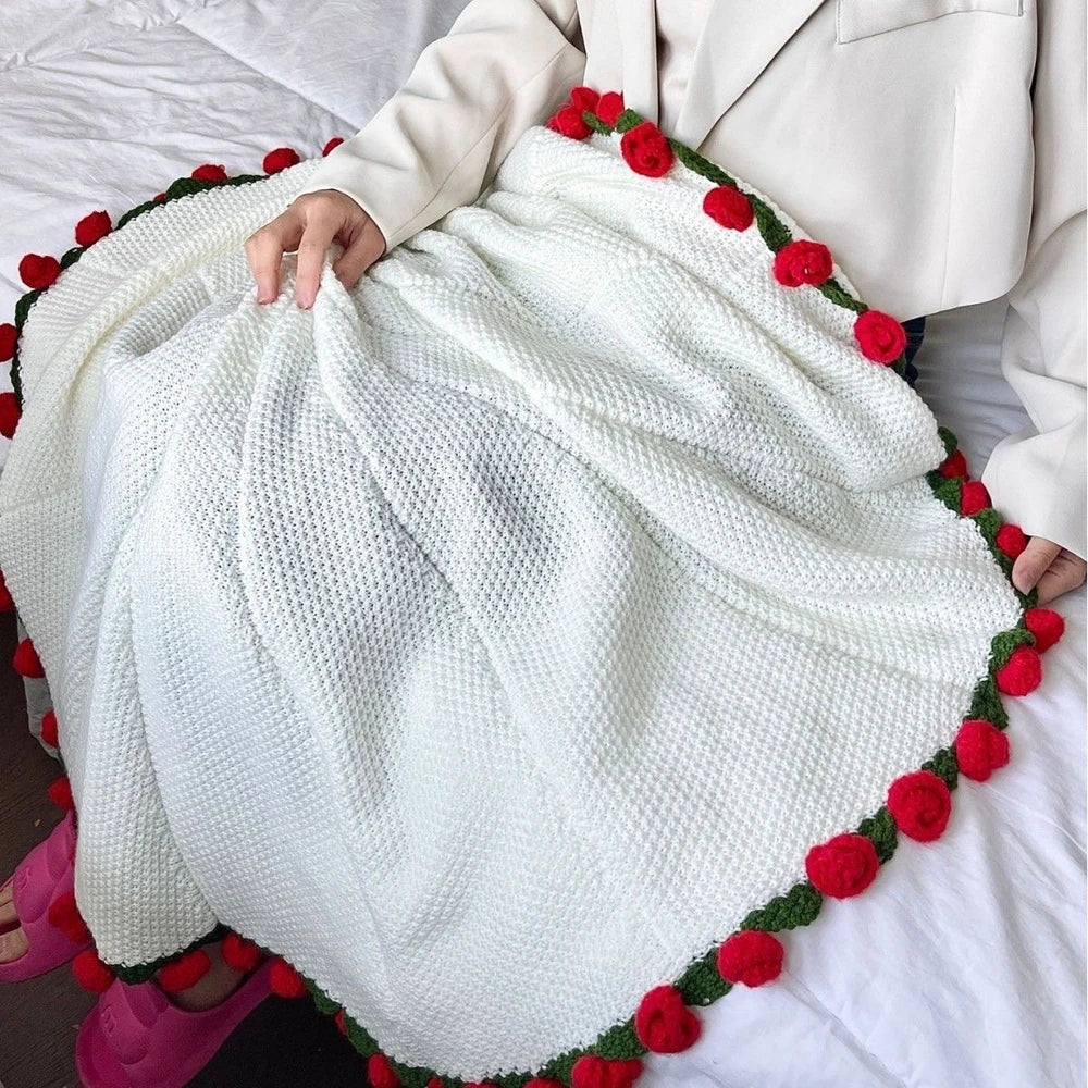 Rose blanket unrolled over lap